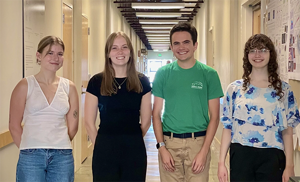 Prior Summer Research Prize winners standing in a hallway.